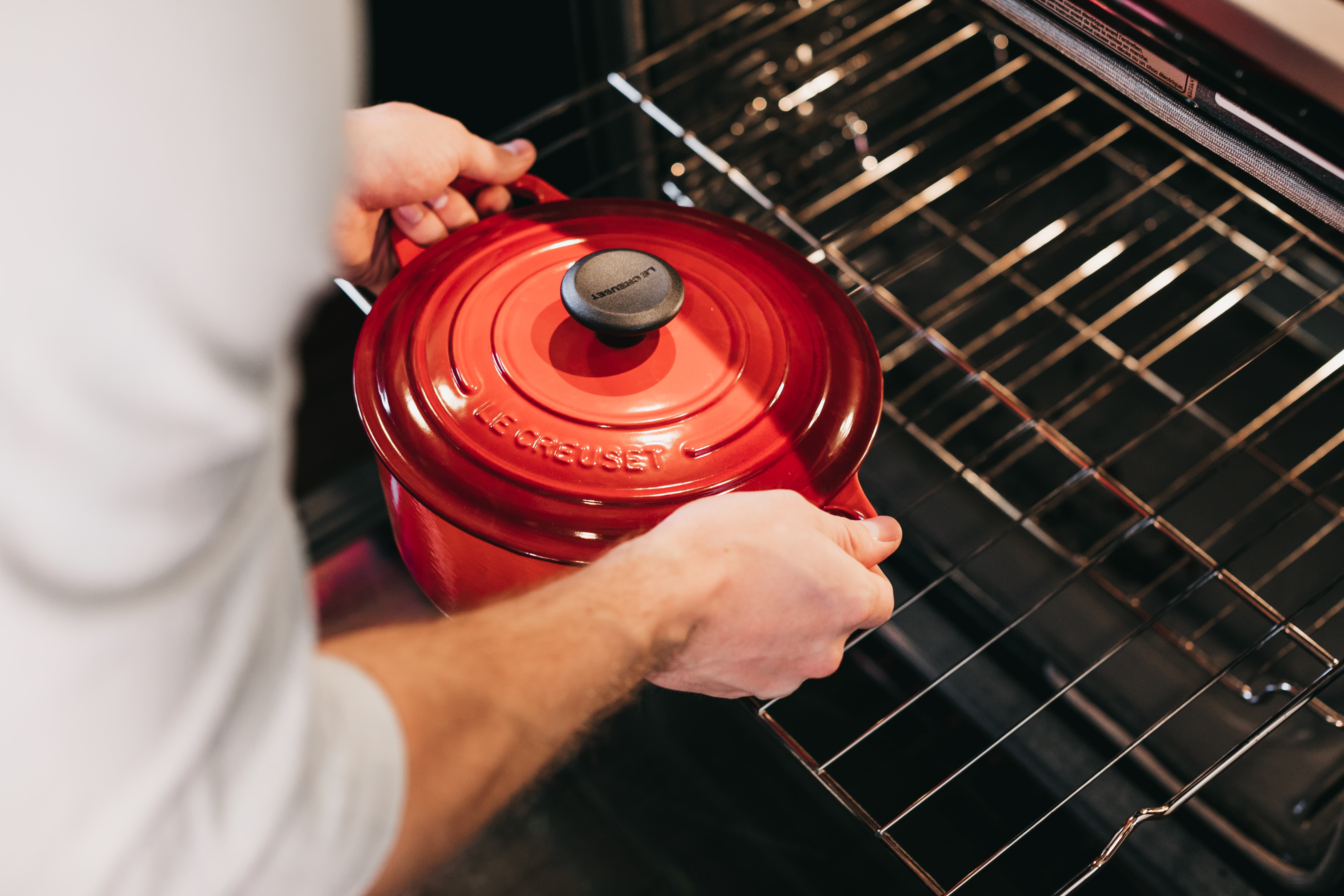 picture of person taking pot out of oven